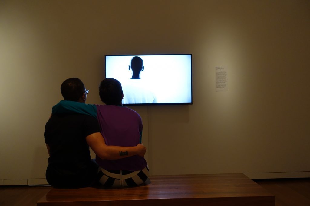 Couple viewing an exhibit on race relations at the Seattle Museum of Art.