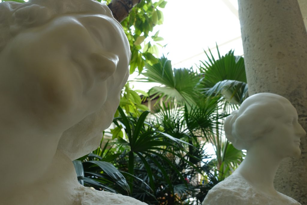 The beautiful, physical company of white marble sculptures in the courtyard garden.