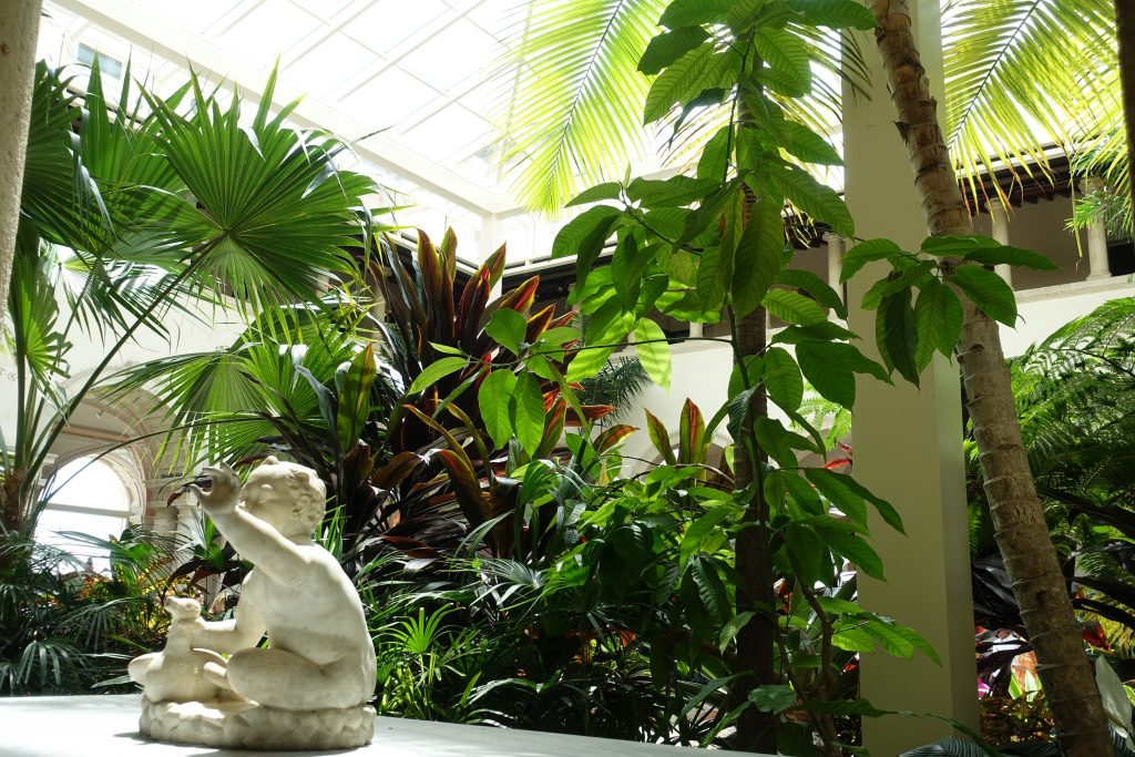 A sweet cherub surrounded by nature in the main home's courtyard.