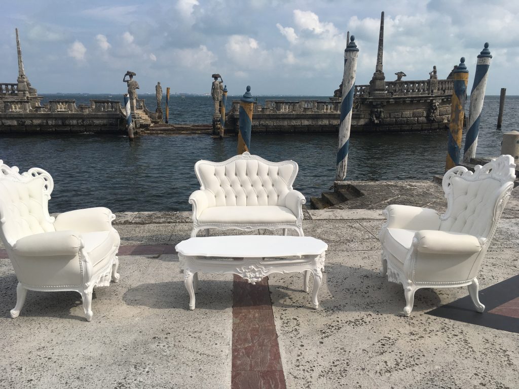 Vizcaya's boat dock was made to look like a shipwrecked vessel with a goddess at the helm, a perfect backdrop to an evening wedding's lounge area.