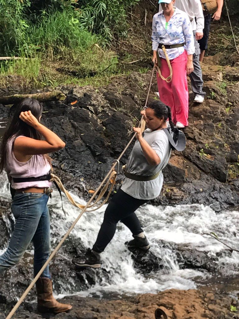 Traversing a waterfall on hike