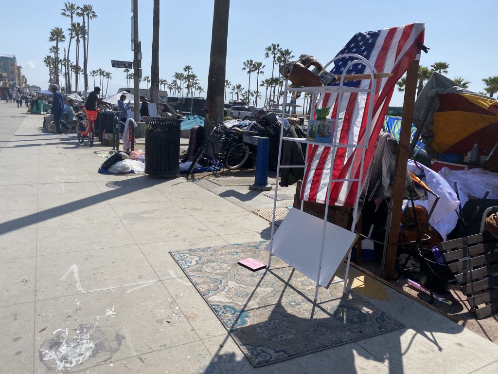 Artists, homeless co-exist on VB's main walk 